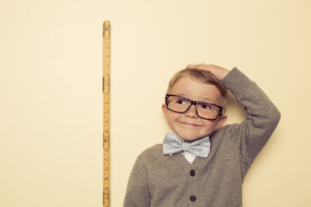 A young boy is looking forward to growing and getting bigger.