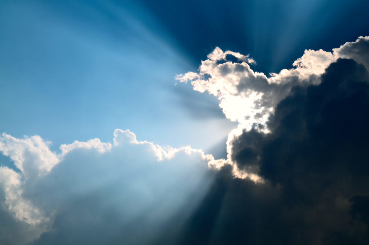 Sunbeam through the black stormy cloud.